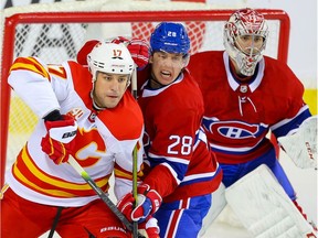 Mike Riley (28), then with the Canadiens, battles Flames forward Milan Lucic in front of the net during a game on Dec. 19.