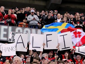 Ottawa Senators fans give a standing ovation for Daniel Alfredsson of the Detroit Red Wings before play of their NHL game in Ottawa, Ont. on Sunday December 1, 2013.