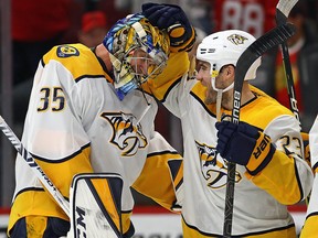 Pekka Rinne of the Nashville Predators celebrates a win against the Chicago Blackhawks and his first career goal with Rocco Grimaldi at the United Center on January 9, 2020 in Chicago. (Jonathan Daniel/Getty Images)