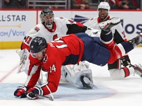 Capitals’ Richard Panik is tripped up in the Senators crease as Sens goalie Craig Anderson and forward Anthony Duclair look on during the second period at Capital One Arena in Washington on Tuesday night. (GETTY IMAGES)