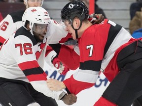 New Jersey Devils defenceman P.K. Subban (left) fights with Ottawa Senators forward Brady Tkachuk last night. (USA TODAY)