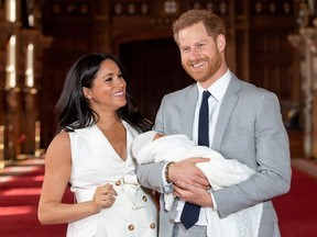 Britain's Prince Harry and Meghan, Duchess of Sussex hold their baby son, who was born on Monday morning, during a photocall in St George's Hall at Windsor Castle, in Berkshire, Britain May 8, 2019.