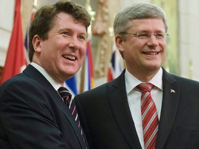 In this June 1, 2011, file photo, then-prime minister Stephen Harper welcomes MP John Williamson at the start of caucus meetings in Ottawa.