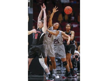 Marlee Ball (L) and Tyra Blizzard go for the ball in the women's Capital Hoops Classic basketball game between the University of Ottawa and Carleton University.