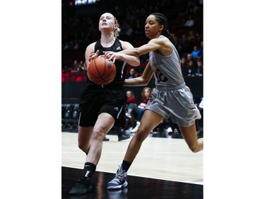 Emma Huff (L) of Carleton is fouled by Savannah Provo in the women's Capital Hoops Classic basketball game between the University of Ottawa and Carleton University.