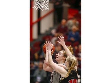 Angela Ribarich takes a shot with Raven Emma Kiesekamp defending in the women's Capital Hoops Classic basketball game between the University of Ottawa and Carleton University.