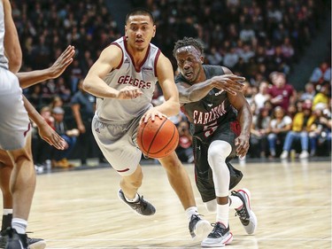 Calvin Epistola of Ottawa drives to the net with Munis Tutu close on his heels in the men's Capital Hoops Classic basketball game between the University of Ottawa and Carleton University.