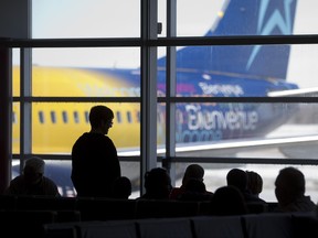 Travellers wait in the departure lounge at London International Airport to board a flight to Santa Clara, Cuba in London, Ont. on March 12, 2015. (CRAIG GLOVER/The London Free Press/Postmedia Network)