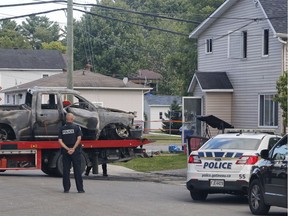 Police investigate a suspicious car fire and building in Buckingham, Quebec on August 31, 2019 .