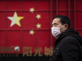 A man wears a protective mask as walk in street on February 10, 2020 in Wuhan, China.