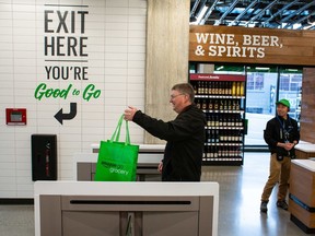 A shopper exits Amazon Go Grocery on Feb. 26, 2020 in Seattle. The store is Amazon's first large retail grocery location that uses the cashier-free model.