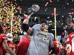 Laurent Duvernay-Tardif of the Kansas City Chiefs raises the Vince Lombardi Trophy after defeating the San Francisco 49ers 31-20 in Super Bowl LIV at Hard Rock Stadium on February 2, 2020 in Miami, Florida.