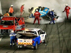 Track workers attend to Ryan Newman, driver of the #6 Koch Industries Ford, following a crash during the NASCAR Cup Series 62nd Annual Daytona 500 at Daytona International Speedway on Feb. 17, 2020.