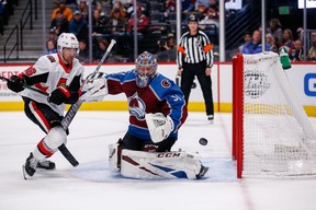 Colorado Avalanche goaltender Philipp Grubauer makes a save against Ottawa Senators centre Colin White during Tuesday's game in Denver.