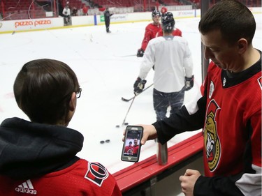 Stephen Giza shows off his selfie to Jessica Dajko (L)  during a Soldier On event at the Canadian Tire Centre in Ottawa, February 03, 2020.  In partnership with the Canadian Forces' Soldier On Program, the Senators Alumni will host a two-day camp at Canadian Tire Centre in support of ill and injured veterans beginning Monday morning. On Monday, Feb. 3, a group of ill and injured veterans from the Canadian Forces (CF) Soldier On Program will arrive at Canadian Tire Centre for a two-day camp with the Senators Alumni.  Photo by Jean Levac/Postmedia News assignment 133187