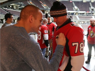 Mark Borowiecki signs Corporel Sam Laidlaw's jersey during a Soldier On event at the Canadian Tire Centre in Ottawa, February 03, 2020.  In partnership with the Canadian Forces' Soldier On Program, the Senators Alumni will host a two-day camp at Canadian Tire Centre in support of ill and injured veterans beginning Monday morning. On Monday, Feb. 3, a group of ill and injured veterans from the Canadian Forces (CF) Soldier On Program will arrive at Canadian Tire Centre for a two-day camp with the Senators Alumni.  Photo by Jean Levac/Postmedia News assignment 133187