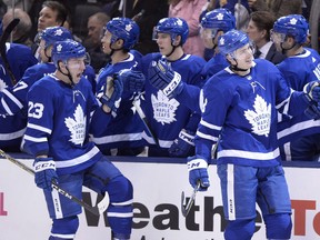 Justin Holl (right) and Travis Dermott (23), along with three other members of the 2017-18 Calder Cup-champion Toronto Marlies blue-line, have suddenly been entrusted with holding the fort on the Maple Leafs’ back end with Jake Muzzin joining Morgan Rielly and Cody Ceci on the injured list.  Frank Gunn/CP