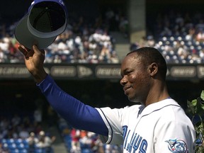 Toronto Blue Jays' Tony Fernandez tips his hat to the crowd as he takes part in a pre-game ceremony against the Tampa Bay Rays in Toronto Sunday Sept. 23, 2001.