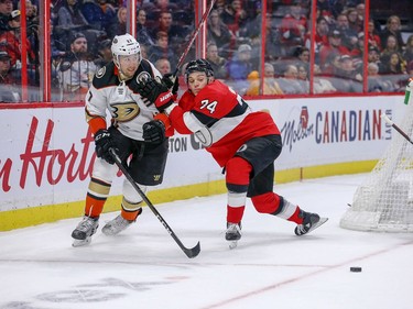 Mark Borowiecki (right) holds off Nick Ritchie in the second period as the Ottawa Senators take on the Anaheim Ducks in NHL action at the Canadian Tire Centre in Ottawa.