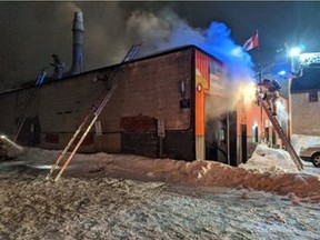 Ottawa Fire Services crews battling a fire at 457-461 Gladstone Ave. in the Centretown neighbourhood on the evening of Saturday, Feb. 15, 2016. The fire was in a one-storey building housing two automotive businesses. Scott Stilborn photo/Twitter.