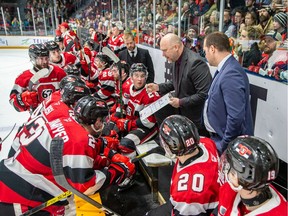 Coach André Tourigny drawing up a play.