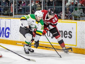 67's defenceman Nikita Okhotyuk battles for puck with London Knights Liam Foudy at The Arena at TD Place on Monday.