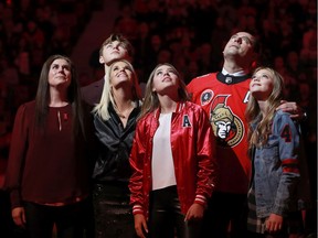 Chris Phillips and his family watch his jersey being lifted to the rafters last night at the Canadian Tire Centre.  
Julie Oliver/Postmedia NEtwork