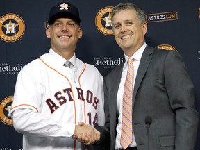 In this Sept. 29, 2014, file photo, then-Houston Astros general manager Jeff Luhnow, right, and A.J. Hinch pose after Hinch is introduced as the new manager of the baseball club in Houston.