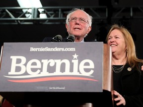 U.S. Democratic presidential candidate Sen. Bernie Sanders (I-VT), with wife Jane Sanders (R), addresses supporters during his caucus night watch party on Feb. 3, 2020 in Des Moines, Iowa.