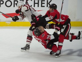 Senators’ Mark Borowiecki takes a hit from Arizona Coyotes’ Lawson Crouse during the third period of Thursday night’s game 
at the Canadian Tire Centre. Borowiecki sustained an ankle injury and will be out indefinitely. (USA TODAY SPORTS)