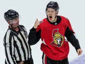Ottawa Senators left wing Brady Tkachuk gestures towards the Montreal Canadiens bench at the end of the game as he is escorted off the ice by linesman Derek Nansen at the Canadian Tire Centre in Ottawa on Saturday.