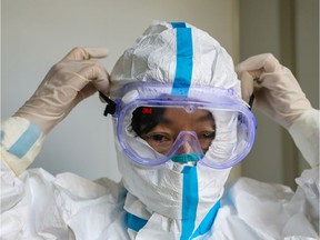 A doctor puts on protective goggles before entering the isolation ward at a hospital, following the outbreak of a new coronavirus in Wuhan, Hubei province, China January 30, 2020.