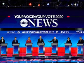 Democratic 2020 U.S. presidential candidates entrepreneur Andrew Yang, former South Bend mayor Pete Buttigieg, Sen. Elizabeth Warren, former vice-president Joe Biden, Sen. Amy Klobuchar and billionaire activist Tom Steyer listen as Sen. Bernie Sanders speaks during the eighth Democratic 2020 presidential debate at Saint Anselm College in Manchester, N.H., Feb. 7, 2020.