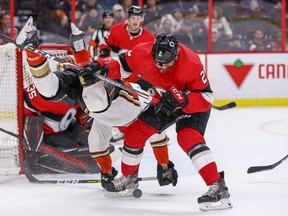 Senators defenceman Dylan DeMelo (right) upends Max Jones and takes a penalty during the second period last night against the Anaheim Ducks at the Canadian Tire Centre.