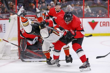 Senators defenceman Dylan DeMelo (right) upends Max Jones and takes a penalty during the second period last night against the Anaheim Ducks at the Canadian Tire Centre.