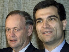 Prime Minister Jean Chretien looks on as former Canadian Alliance MP Joe Peschisolido announces why he left the party to join the Liberals on Parliament Hill, in Ottawa on Sunday Jan. 27, 2002.