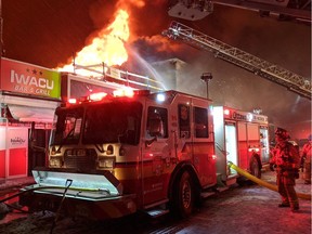 Ottawa firefighters battle a three-alarm blaze in a retail building on the north side of Montreal Road between North River Road and Vanier Parkway, Feb. 27, 2020.