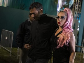 Lady Gaga, centre, leaves after Super Bowl LIV between with Michael Polansky, left, and her security guards at Hard Rock Stadium in Miami Gardens, Fla., on Feb. 2, 2020. (EVA MARIE UZCATEGUI/AFP via Getty Images)