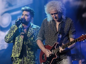 Adam Lambert, left, performs with Brian May of Queen during Fire Fight Australia at ANZ Stadium on Sunday in Sydney, Australia.