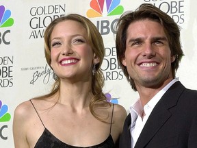 Actress Kate Hudson poses with presenter actor Tom Cruise after winning Best Actress in a Supporting Role for her role in the film "Almost Famous," during the 58th Annual Golden Globes in Beverly Hills, Calif., Jan. 21, 2001. (LUCY NICHOLSON/AFP via Getty Images)