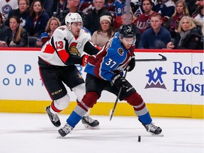 Colorado Avalanche left wing J.T. Compher controls the puck against Ottawa Senators left wing Nick Paul in the first period at the Pepsi Center on Tuesday.