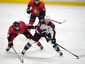 Ottawa Senators defenseman Mike Reilly (5) battles with Colorado Avalanche left wing Gabriel Landeskog (92) in the third period at the Canadian Tire Centre.