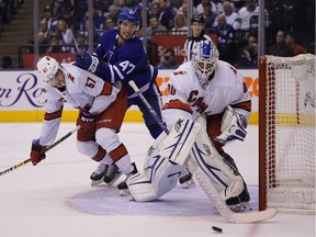 Carolina Hurricanes emergency goaltender David Ayres clears the puck as Toronto Maple Leafs forward Pierre Engvall and Carolina Hurricanes defenceman Trevor van Riemsdyk battle for position at Scotiabank Arena.