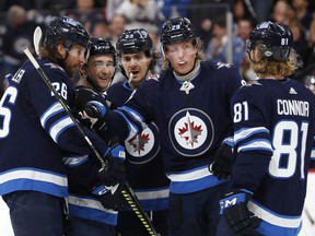 Winnipeg Jets right wing Patrik Laine (29) celebrates with teammates after scoring a goal in the second period against the Ottawa Senators.