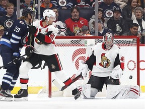 Feb 8, 2020; Winnipeg, Ottawa Senators goaltender Craig Anderson (41) watches the puck in the first period as Ottawa Senators defenseman Ron Hainsey (81) defends and Winnipeg Jets right wing Patrik Laine (29) looks for a rebound at Bell MTS Place.