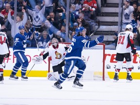 Maple Leafs’ Mitch Marner celebrates his goal in overtime as Senators goaltender Craig Anderson looks on on Saturday night in Toronto. (USA TODAY SPORTS)