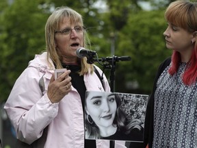 Janet Coy from Romford in Essex, England addresses the crowd during a candlelight vigil for murdered British tourist Grace Millane at Cathedral Square in Christchurch, New Zealand, Wednesday, Dec. 12, 2018.