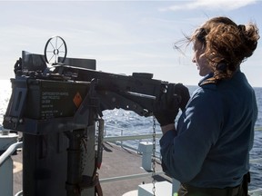 A crew member aboard HMCS WHITEHORSE conducts weapon maintenance on Feb. 10, 2020.
