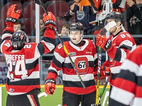 Ottawa 67's teammates Joseph Garreffa (24) and Kevin Bahl (88) start the celebration with Cameron Tolnai, middle, after Tolnai scored the overtime winning goal against the Barrie Colts during an Ontario Hockey League game at the TD Place arena in Ottawa on Saturday, Feb. 29, 2020. Ottawa won the game 4-3 in overtime. Valerie Wutti/Ottawa 67's.