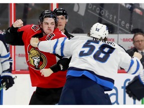 Ottawa's Drake Batherson (19) drops the gloves against Jansen Harkins (58) near the end of the first period action between the Ottawa Senators and the Winnipeg Jets Thursday (feb 20, 2020) at Canadian Tire Centre. Julie Oliver/Postmedia